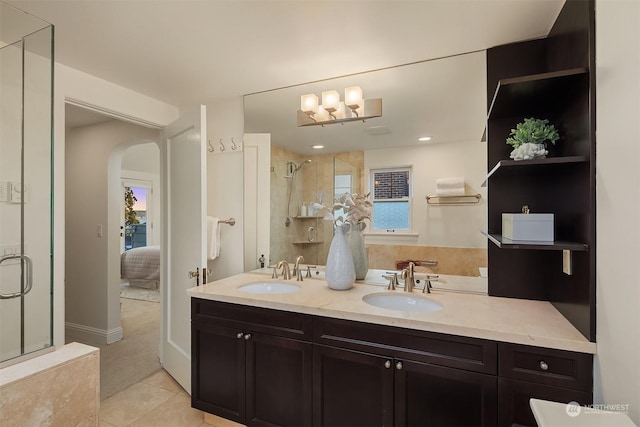 bathroom featuring tile patterned flooring, vanity, and walk in shower