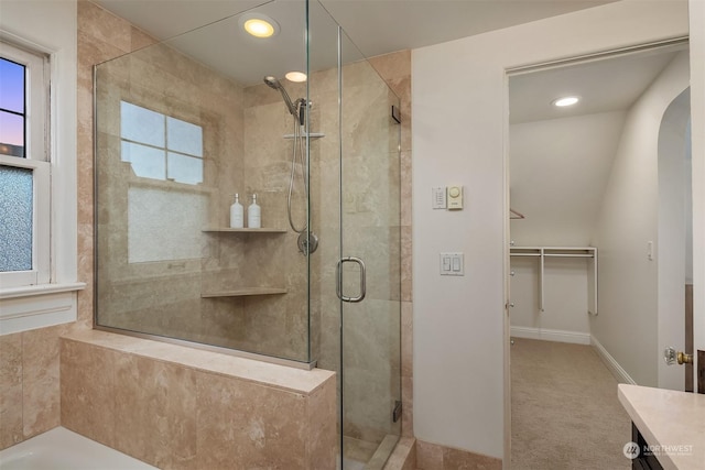 bathroom featuring vanity and a shower with shower door