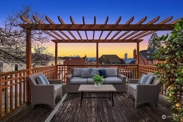 deck at dusk with a pergola and outdoor lounge area