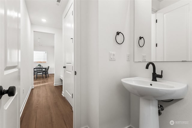 bathroom with wood-type flooring