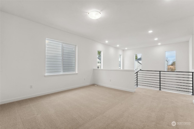 unfurnished room with light carpet