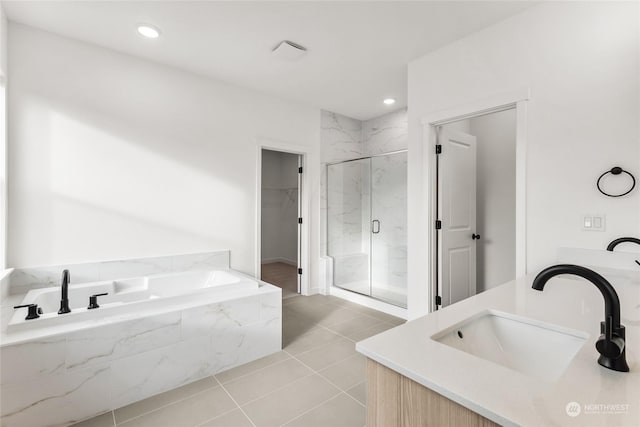 bathroom with tile patterned flooring, vanity, and independent shower and bath