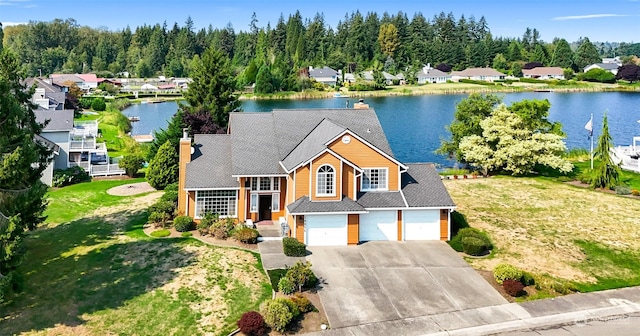 view of front of home featuring a water view, a front yard, and a garage