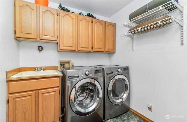 laundry area with cabinets, independent washer and dryer, and sink