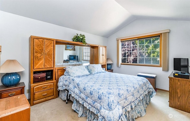 carpeted bedroom featuring vaulted ceiling