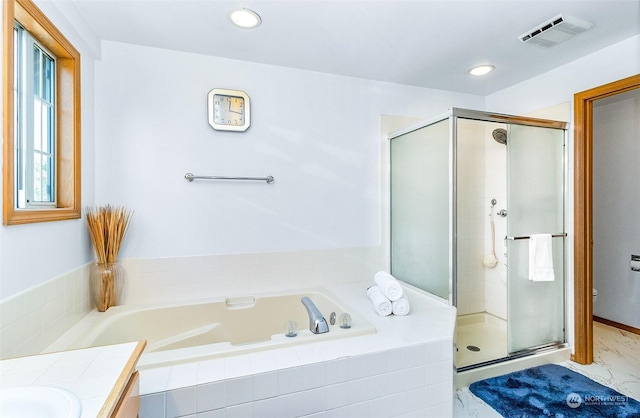 bathroom with vanity and shower with separate bathtub