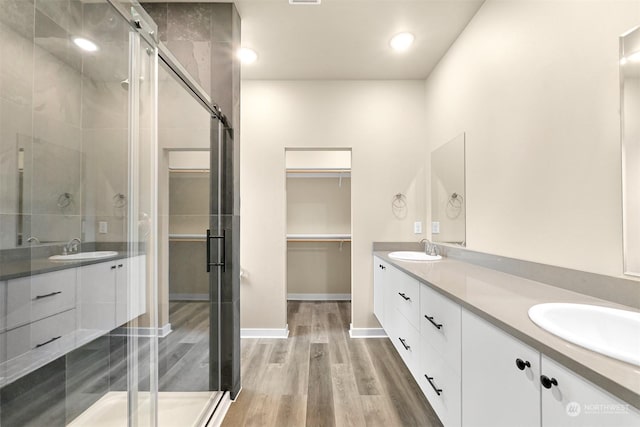 bathroom featuring vanity, hardwood / wood-style flooring, and an enclosed shower