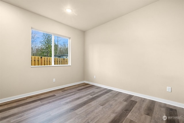 unfurnished room with hardwood / wood-style floors