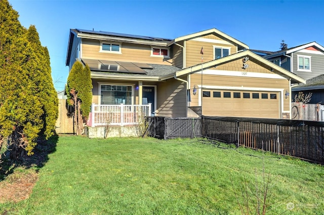 view of front of house featuring a garage, a front lawn, covered porch, and solar panels