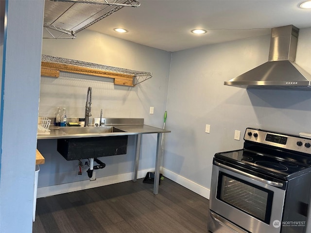 kitchen featuring stainless steel counters, dark hardwood / wood-style flooring, stainless steel electric range oven, and wall chimney exhaust hood