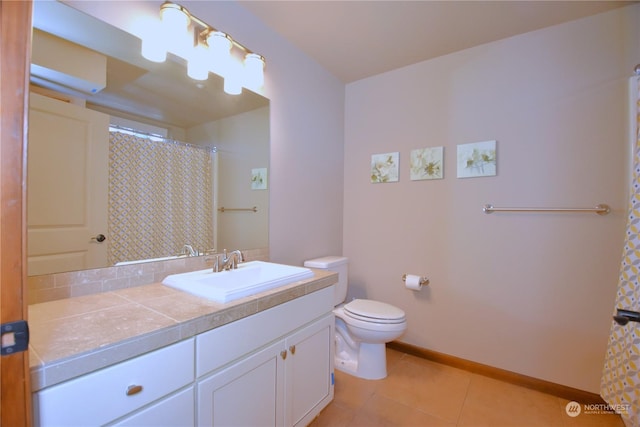 bathroom featuring toilet, vanity, tile patterned floors, and walk in shower