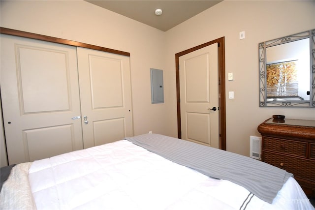 bedroom with a closet and electric panel