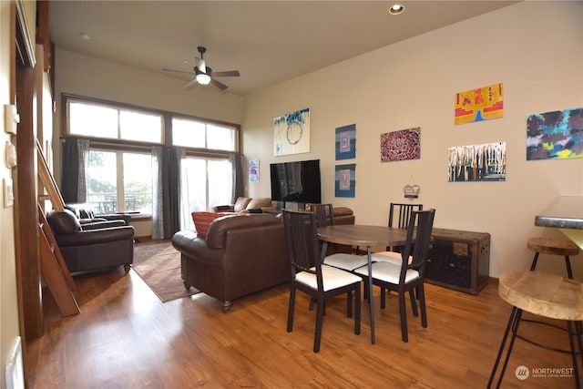 dining area with hardwood / wood-style flooring and ceiling fan