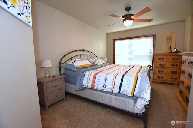 bedroom featuring ceiling fan and carpet