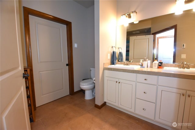 bathroom with tile patterned floors, vanity, and toilet