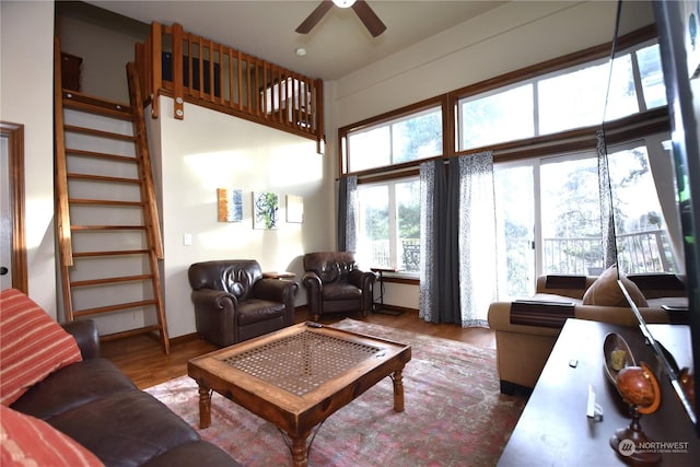 living room featuring hardwood / wood-style flooring and ceiling fan