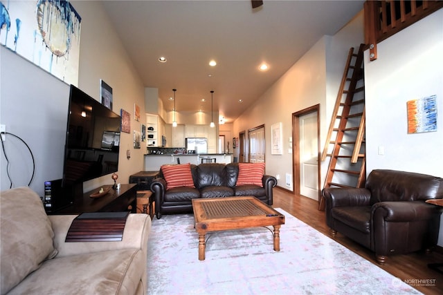 living room with dark wood-type flooring and lofted ceiling