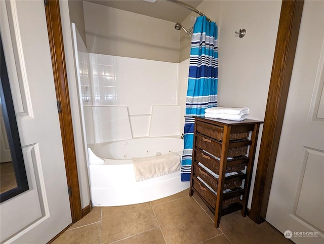 bathroom featuring shower / bath combo with shower curtain and tile patterned flooring