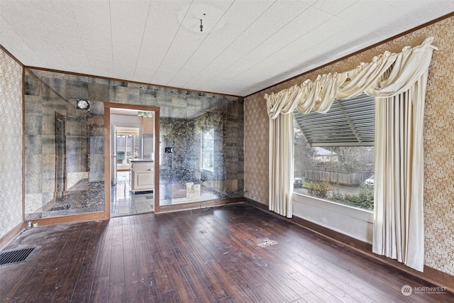 unfurnished room with wood-type flooring and ornamental molding