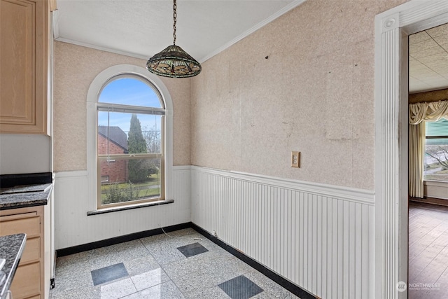 unfurnished dining area with plenty of natural light and ornamental molding