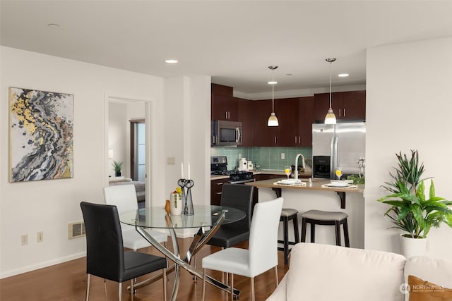 dining space with dark wood-type flooring