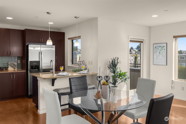 dining room with plenty of natural light and dark hardwood / wood-style flooring