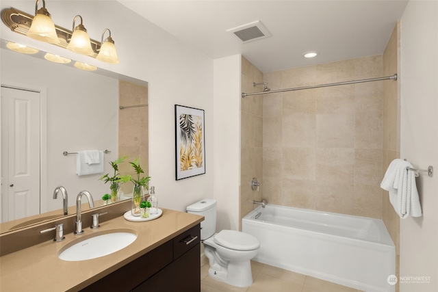 full bathroom featuring tiled shower / bath, vanity, toilet, and tile patterned flooring