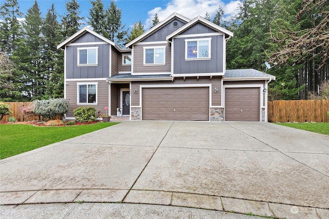 craftsman inspired home with a garage and a front lawn