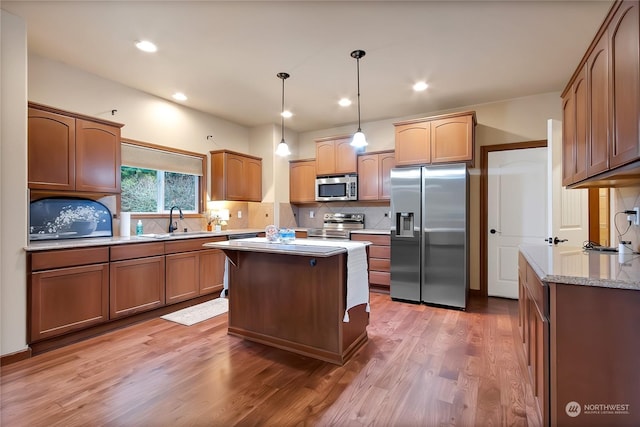 kitchen with sink, dark wood-type flooring, appliances with stainless steel finishes, decorative backsplash, and decorative light fixtures