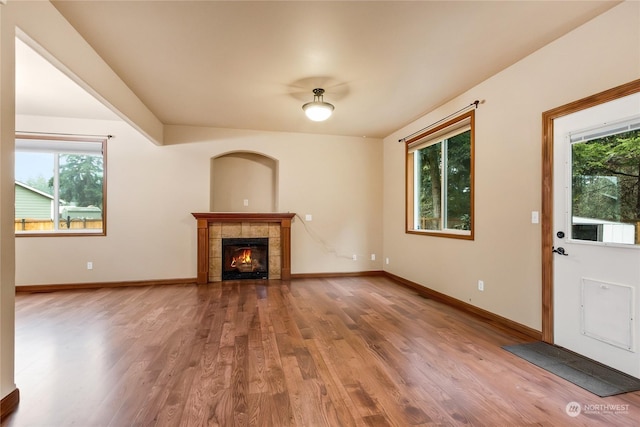 unfurnished living room with plenty of natural light, hardwood / wood-style floors, and a fireplace