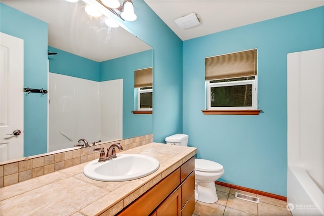 bathroom with tile patterned flooring, vanity, and toilet