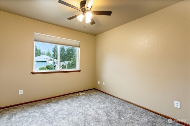 unfurnished room featuring ceiling fan and carpet