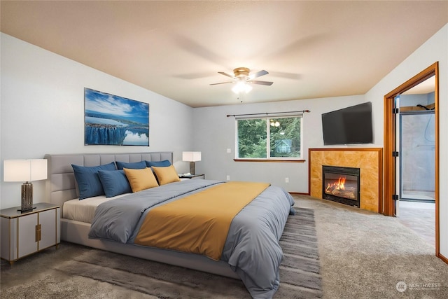 bedroom featuring ceiling fan, carpet, and a tile fireplace