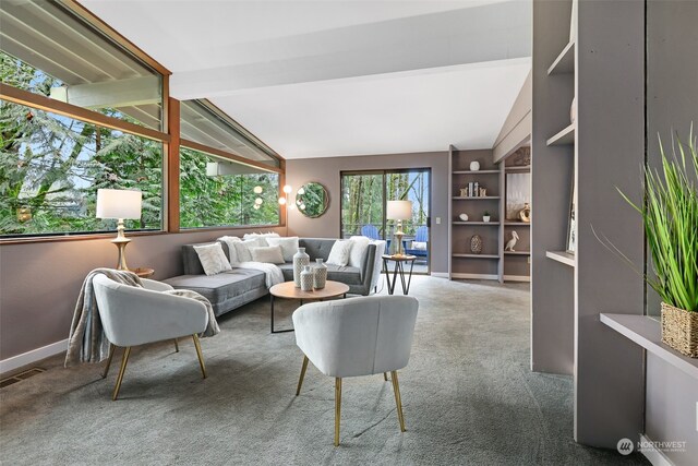 carpeted living room featuring lofted ceiling with beams and built in features