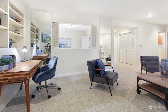 office area featuring light carpet and built in shelves