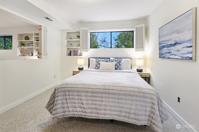 bedroom featuring carpet flooring and multiple windows