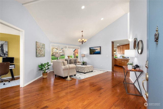 living room featuring vaulted ceiling, a chandelier, and hardwood / wood-style floors