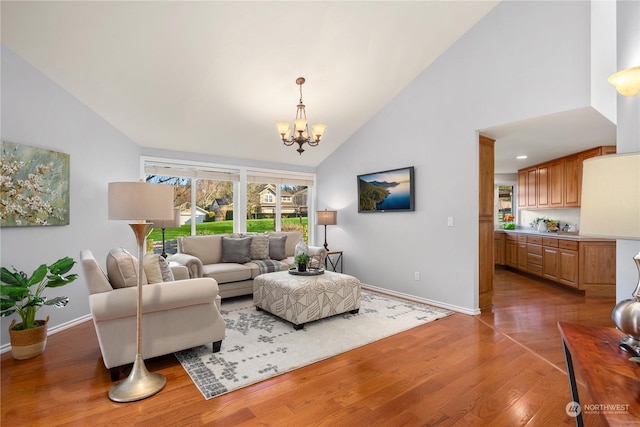 living room featuring an inviting chandelier, high vaulted ceiling, and dark hardwood / wood-style floors