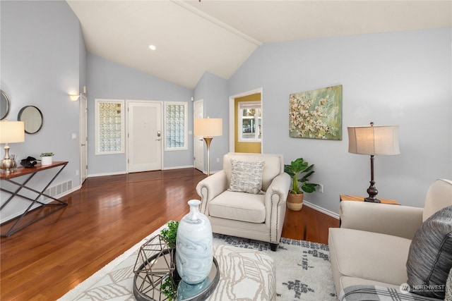 living room with lofted ceiling and wood-type flooring