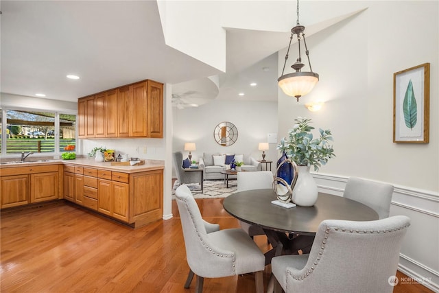 dining area with sink and light wood-type flooring