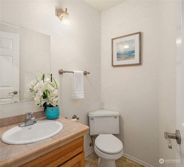 bathroom with vanity, tile patterned flooring, and toilet