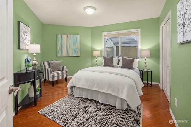 bedroom featuring hardwood / wood-style floors and a closet