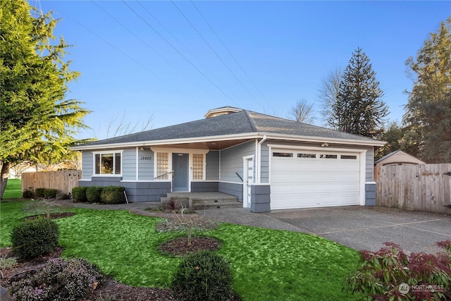 ranch-style house featuring a garage and a front lawn