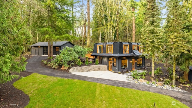 view of front of house with an outbuilding, a garage, and a front yard