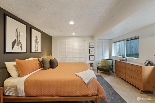 carpeted bedroom featuring a textured ceiling