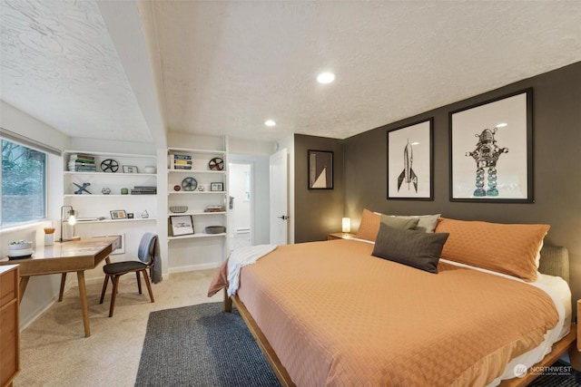 carpeted bedroom featuring a textured ceiling