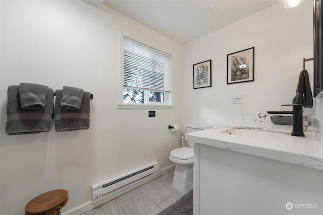 bathroom featuring tile patterned flooring, vanity, toilet, and baseboard heating