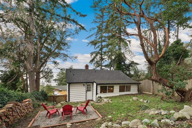 back of property featuring a fire pit