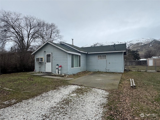 rear view of property featuring a mountain view and a patio