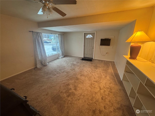 carpeted foyer featuring ceiling fan